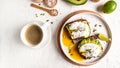 Delicious breakfast or snack with egg poached on avocado and a cup of coffee on a light background, top view Royalty Free Stock Photo