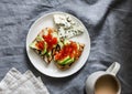 Delicious breakfast or snack - red caviar, avocado sandwiches, blue cheese and coffee on grey background Royalty Free Stock Photo