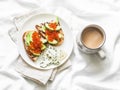 Delicious breakfast or snack - red caviar, avocado sandwiches and blue cheese on light background