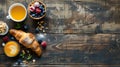 Delicious breakfast spread on a rustic wooden table. Fresh croissant, berries, and orange juice. Ideal for a healthy Royalty Free Stock Photo