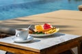 Delicious breakfast on the swimming pool in luxury resort Royalty Free Stock Photo