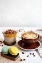 Delicious breakfast on the table. The cup of coffee, mango pudding and macarons at the white table Royalty Free Stock Photo