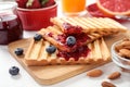 Delicious breakfast with toasted bread, jam and berries on white table Royalty Free Stock Photo