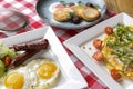 Delicious breakfast. Traditional British breakfast, fried eggs with sausages, vegetable omelette, cheese pancakes