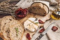 Delicious brie cheese Camembert with sun-dried tomatoes with olive oil and homemade bread. Traditional quick snack for home Royalty Free Stock Photo