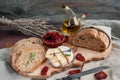 Delicious brie cheese Camembert with sun-dried tomatoes with olive oil and homemade bread. Traditional quick snack for home Royalty Free Stock Photo