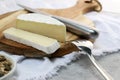 delicious brie cheese with cut slice on wooden plate with copy space