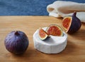 Delicious brie cheese with figs on wooden board