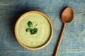 Delicious broccoli cream soup served on blue table, flat lay Royalty Free Stock Photo