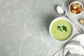 Delicious broccoli cream soup served on grey table, flat lay. Space for text Royalty Free Stock Photo