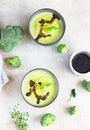 Delicious broccoli cream soup served with spicy oil and mint. Vegetarian dish. Top view Royalty Free Stock Photo