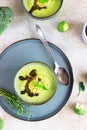 Delicious broccoli cream soup served with spicy oil and mint. Vegetarian dish. Top view. Light concrete background Royalty Free Stock Photo