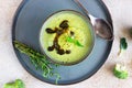 Delicious broccoli cream soup with spicy oil and mint. Vegetarian dish. Top view. Concrete background Royalty Free Stock Photo