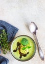 Delicious broccoli cream soup with spicy oil and mint. Vegetarian dish. Top view. Concrete background Royalty Free Stock Photo