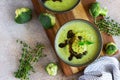 Delicious broccoli cream soup with spicy oil and mint. Vegetarian dish. Top view. Concrete background Royalty Free Stock Photo