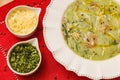 Delicious broccoli green broth, green broccoli soup, vegetarian, with grated parmesan cheese and parsley, with wooden background