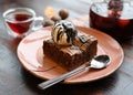 Delicious brownie cake with a ball of ice cream