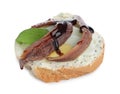 Delicious bruschetta with anchovies, eggs, basil and sauce on white background