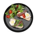 Delicious bruschettas with anchovies, cream cheese, eggs and tomatoes isolated on white, top view