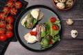 Delicious bruschettas with anchovies, cream cheese, eggs and tomatoes on wooden table, flat lay