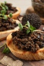 Delicious bruschettas with truffle sauce and microgreens on wooden table, closeup Royalty Free Stock Photo