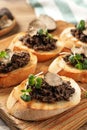 Delicious bruschettas with truffle sauce and microgreens on wooden table, closeup Royalty Free Stock Photo