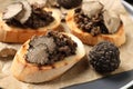 Delicious bruschettas with truffle sauce on plate, closeup