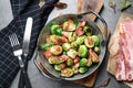 Delicious Brussels sprouts with bacon served on table, flat lay