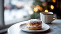 Delicious bun with cream and a coffee cup on a marble cafe table near the window, on cozy festive background. Generative AI