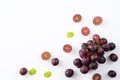 Delicious bunch of grapes fruit spilled over white table background Royalty Free Stock Photo