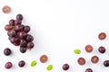 Delicious bunch of grapes fruit spilled over white table background Royalty Free Stock Photo