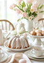 Delicious Bundt cake with icing still life. Beautiful white colors morning table decoration with lace tablecloth and napkins,