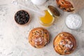 Delicious buns with raisins and honey, powdered sugar on a light concrete table. fresh bakery. breakfast. bread. top view