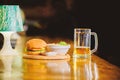 Delicious burger. Burger with cheese meat and salad. Pub food and mug of beer. Fast food concept. Burger menu. High