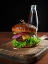 Delicious burger with fried beef cutlet and onions. crispy white wheat flour bun with sesame seeds Royalty Free Stock Photo