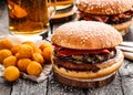 Delicious burger with fried potato balls and beer Royalty Free Stock Photo