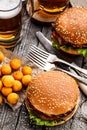 Delicious burger with fried potato balls and beer Royalty Free Stock Photo