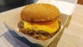 A delicious burger and grilled cheese on top of the meat decorated in a box Royalty Free Stock Photo