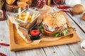 Delicious burger with lamb cutlet and vegetables Royalty Free Stock Photo