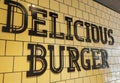 Delicious burger sign on the wall