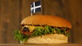 Delicious burger with small flag of Saint Pirans on top of them with toothpicks. Yummy hamburger rotating.