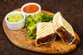 Delicious burito with sauce Royalty Free Stock Photo