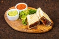 Delicious burito with sauce Royalty Free Stock Photo