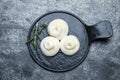 Delicious burrata cheese with rosemary on grey table, top view