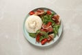 Delicious burrata salad on light grey marble table, top view