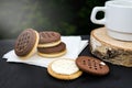 Delicious butter cream sandwich and cup of tea or coffee on the table. Close-up. Royalty Free Stock Photo