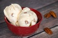 Butter pecan ice cream in a red bowl