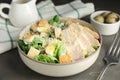 Delicious Caesar salad in bowl on grey table, closeup Royalty Free Stock Photo
