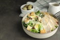 Delicious Caesar salad in bowl on grey table, space for text Royalty Free Stock Photo