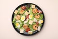 Delicious Caesar salad with shrimps on beige table, top view Royalty Free Stock Photo